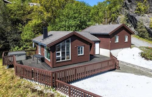 a home with a large deck and a house at Awesome Home In Nedstrand With Sauna in Vik