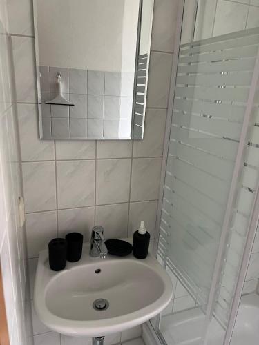 a bathroom with a sink and a mirror at Ferienwohnung P5 in Schmölln