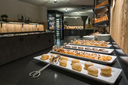 a buffet line with several trays of pastries at Hotel Christoph in Valdaora