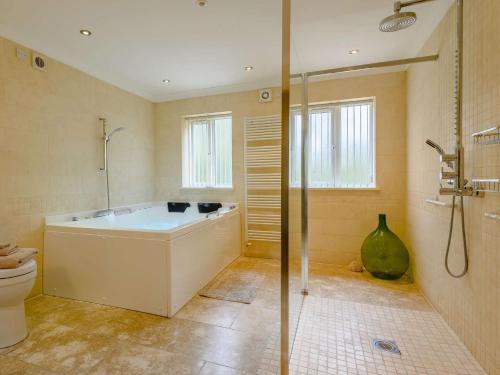 a bathroom with a tub and a shower and a toilet at 1 Bed in Nantyglo 58304 in Nantyglo