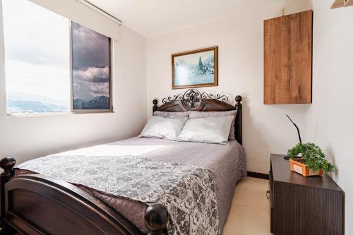 a bedroom with a bed and a window at City views Air-conditioning Heated pool in Envigado