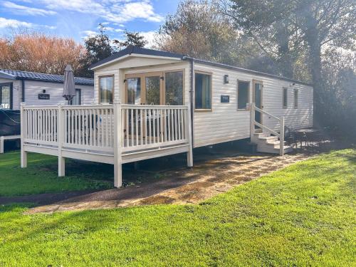 a white cabin with a porch and a deck at 7 Burnham in Burnham on Sea