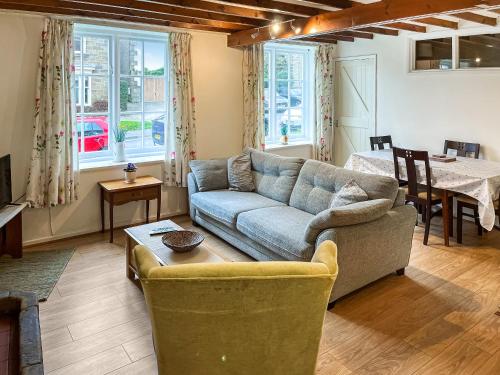 a living room with a couch and a table at Jennys Cottage in Osmotherley