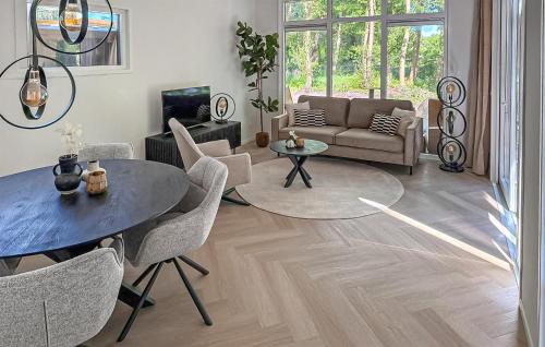 a living room with a table and chairs and a couch at Amazing Home In Zeijen With Wifi in Peest