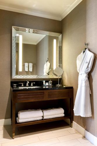 a bathroom with a sink and a mirror at Ambassador Hotel Oklahoma City, Autograph Collection in Oklahoma City
