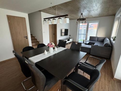a dining room and living room with a table and chairs at Vila Linet in Poprad