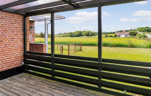 a screened porch with a view of a field at 1 Bedroom Nice Home In Hurup Thy in Ullerup