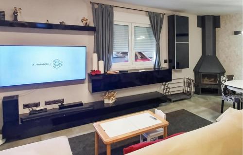 a living room with a large flat screen tv at Awesome Home In Alcora With Heated Swimming Pool in San Juan de Moró