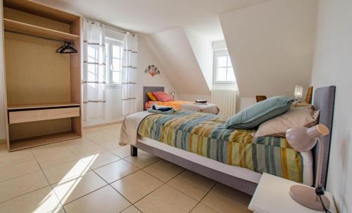 Un dormitorio con una cama con sábanas coloridas. en Le charles augustin, en Lusigny-sur-Barse