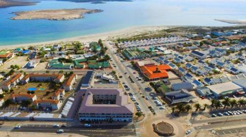 an aerial view of a city with a beach at Atlantic Apartment - spacious kite accommodation in Langebaan