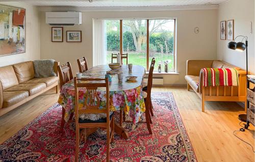 a living room with a table and a couch at 3 Bedroom Gorgeous Home In Søby Ærø in Soby Mark