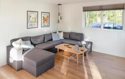 a living room with a couch and a table at Amazing Home In Glesborg With Sauna in Fjellerup Strand