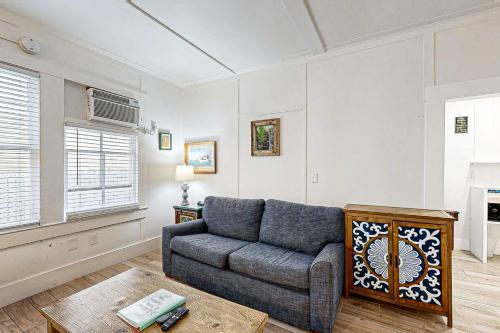 a living room with a couch and a table at Gardenia Getaway in Key West