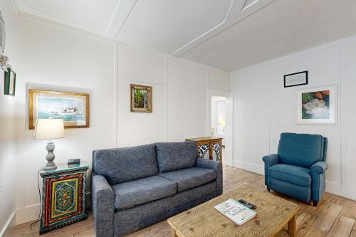 a living room with a couch and a chair at Gardenia Getaway in Key West