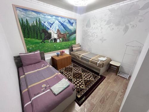 a room with a painting on the wall at Милый дом in Tokmok