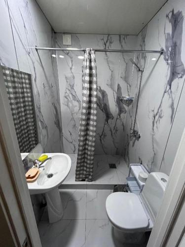 a bathroom with a toilet and a sink at Милый дом in Tokmok