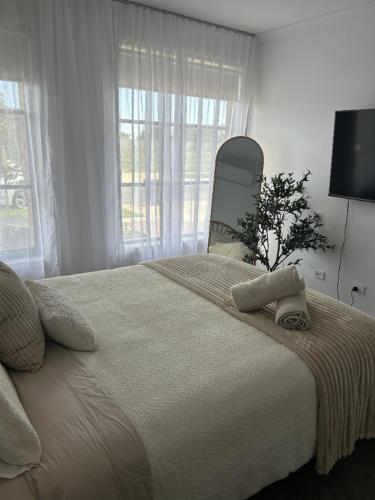 a bedroom with a large bed with towels on it at The Nagambie Stay in Nagambie