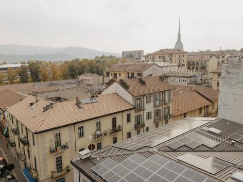 an aerial view of a city with buildings and roofs at Mole Turin Suite in Turin