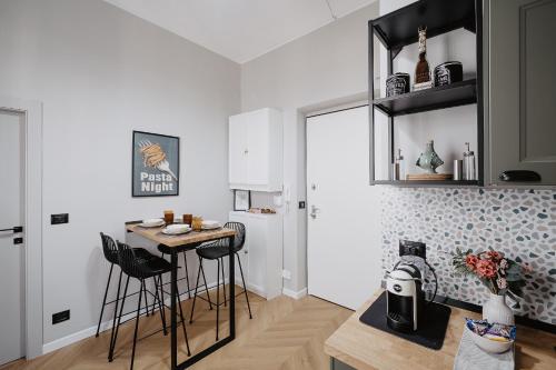a kitchen with a table and chairs in a room at Mole Turin Suite in Turin