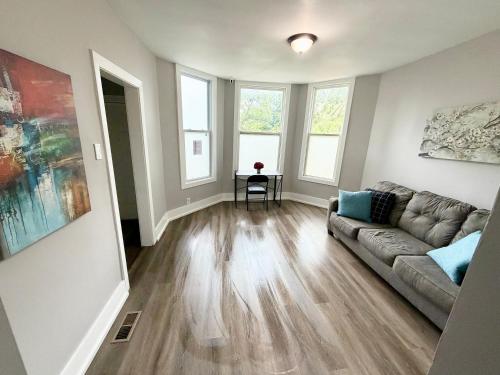 a living room with a couch and some windows at Beautiful Home Near Downtwon - Free Parking! in Chicago