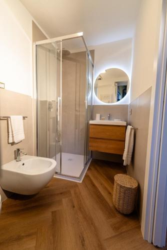 a bathroom with a white sink and a shower at Casa Lilla in Varese