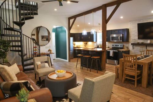 a living room with a staircase and a kitchen at The Horse Carriage 2 Miles From Foxwoods Casino in Preston