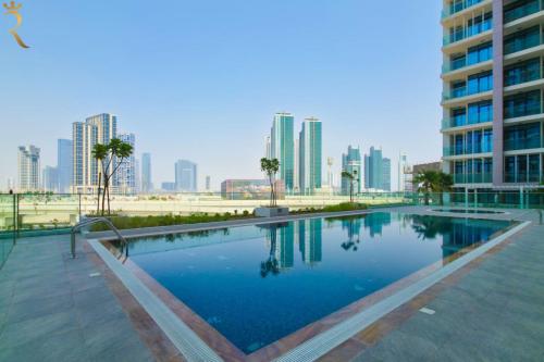a swimming pool in a city with tall buildings at Stylish 1BR - Maryah Vista Luxe Escape in Abu Dhabi