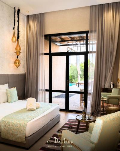 a bedroom with a bed and a living room at Al Destino Villa Riad Spa Luxury Marrakech in Marrakesh