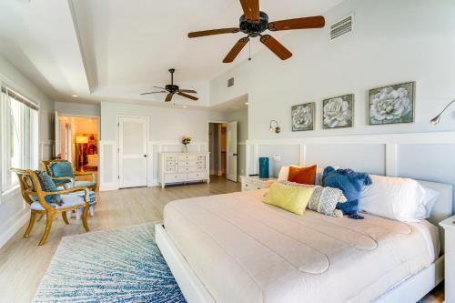 a bedroom with a large bed and a ceiling fan at Walk to Wabasso Beach Home with Hot Tub and Bikes in Sebastian