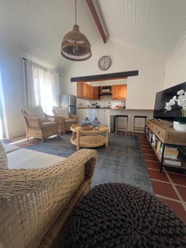 a living room with a couch and a table at Wild Riverside Cottage in Velddrif