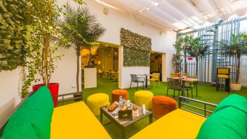 a room with plants and tables and chairs at Rent-inn Boutique Hotel in Rabat