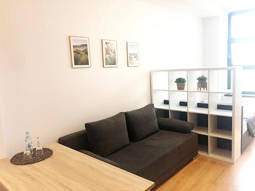 a living room with a couch and a table at Apartimento Hydral Sole in Wrocław