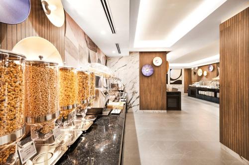 a restaurant with a display case filled with food at Riu Plaza Toronto in Toronto