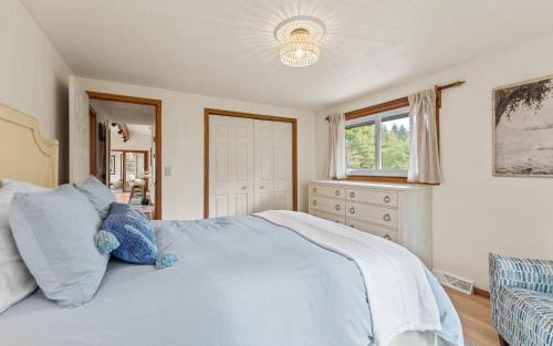 a bedroom with a large bed and a window at Scenic Shores, Your Front Row Seat to Lake Michigan Sunsets in Rothbury