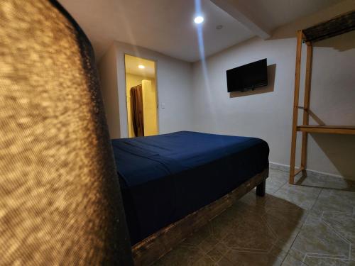a bedroom with a bed and a tv in a room at Casa Seloria in Cancún