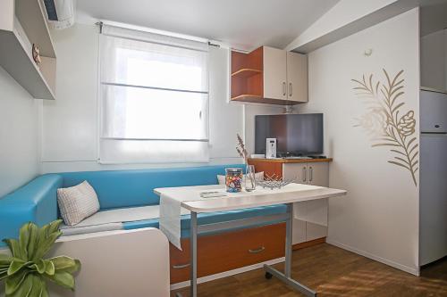 a small kitchen with a table and a window at Auto-kamp Dvije suze 3 in Brištane