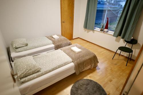 a bedroom with two beds and a window at Villa Lucky in Rovaniemi