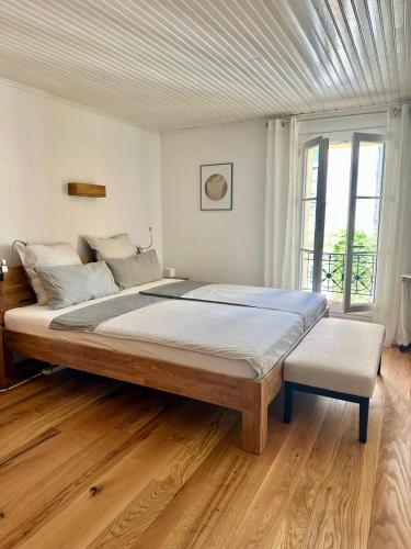 a bedroom with a large bed and a window at La fleur d'oranger in Aigues-Mortes