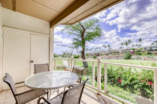 a patio with a table and chairs on a balcony at Wailea Grand Champions 87 in Wailea