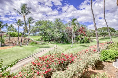 a garden with pink flowers and palm trees at Wailea Grand Champions 87 in Wailea