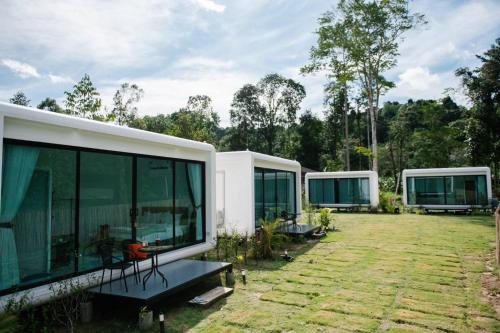 a group of modular homes in a yard at Koh Kood AYA Homestay in Ko Kood