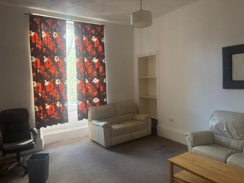 a living room with a couch and a window at Vintage Thistle House in Glasgow