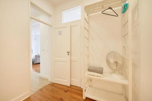 a bathroom with a shower with a toilet and a mirror at Cozy Apartment with Castel view in Lisbon