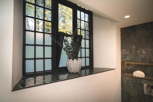 a vase on a window sill with a vase at Old School House, Halkyn in Halkyn
