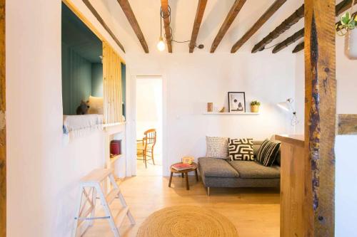 a living room with a couch and a chair at Design Studio em Alcântara- LX Factory- 1 MAIO in Lisbon