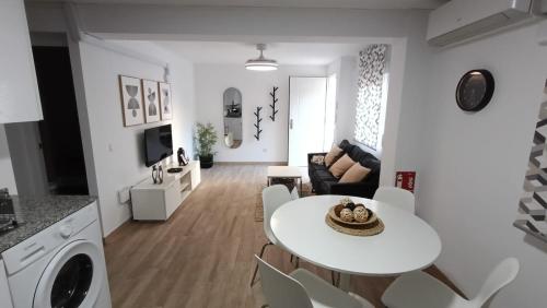 a white living room with a white table and chairs at Casa Los Naranjos in Marbella