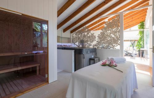 a kitchen with a table with pink flowers on it at Casa Son Sant Jordi in Pollença
