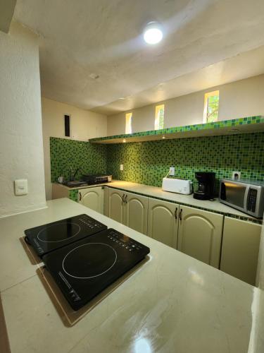 a kitchen with a counter with a stove in it at Casa Seloria in Cancún