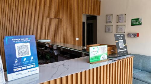 a counter in a room with two signs on it at Hotel Vesta Boutique in Neiva