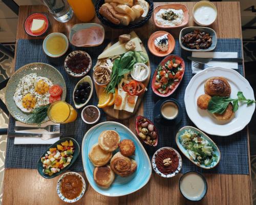 a table topped with plates of food and bowls of food at Hotel Poem in Istanbul